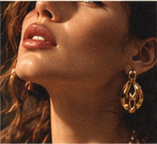 Mood image: a face lifted into cinematic light, with a sculptural gold earring